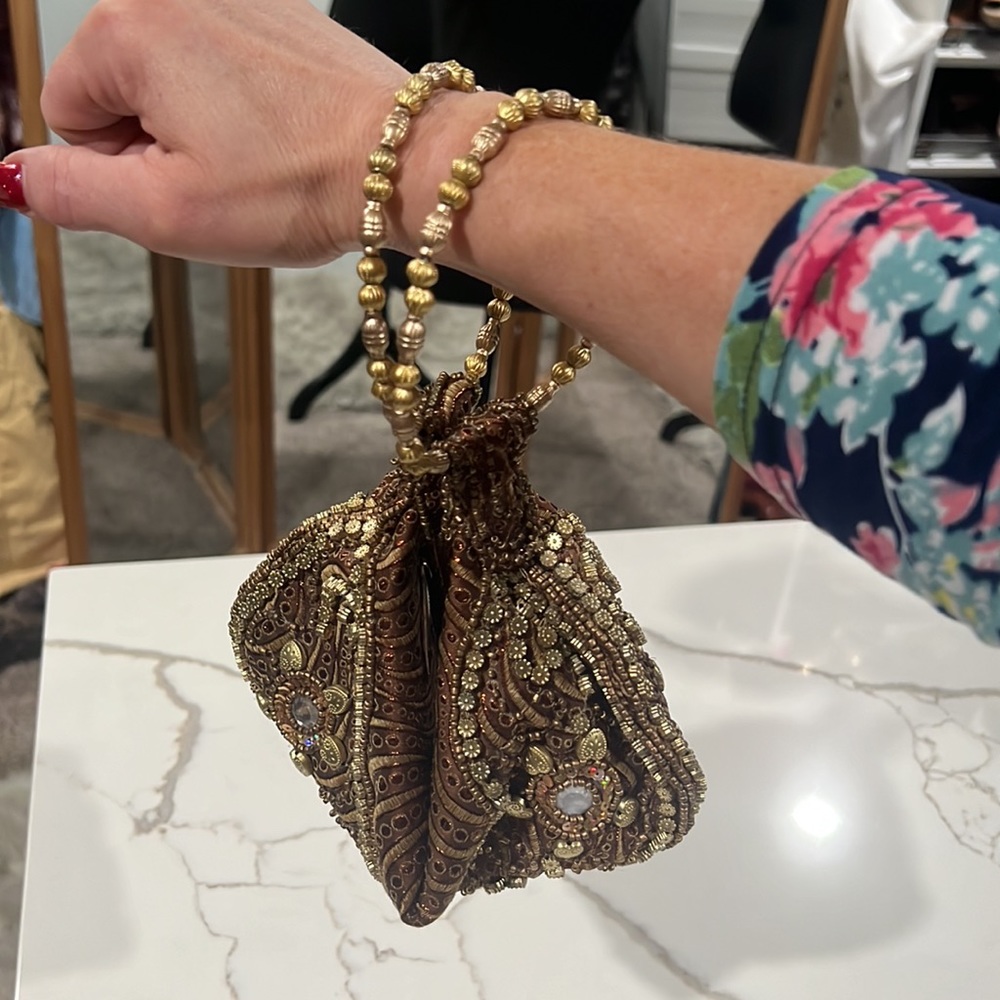 Copper and gold wristlet with beaded embellishments and bracelets for carrying